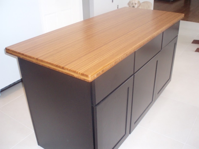 Bamboo Countertop With Black Island Cabinets